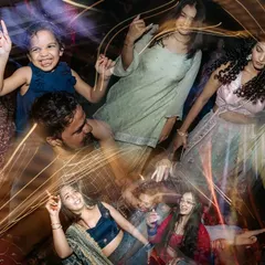 The dance floor is a place of pure joy. This long-exposure shot captures the movement and laughter of guests of all ages, creating a beautiful chaos of light and emotion.