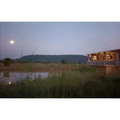 A serene view from the deck of the Waghoba Ecolodge, overlooking the lake and the hills. We created this water body to attract biodiversity and to serve as a beautiful, reflective foreground to the wilderness beyond.