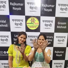 Two happy clients showing off their matching festive designs at our studio. It's always fun to get mehndi done with a friend or family member.