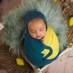 Even at 2.5 months, we can capture beautiful, sleepy portraits. This little one is styled in a vibrant yellow and teal swaddle for a pop of color.