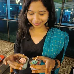 A participant proudly shows off the two beautiful succulent-themed candles she made at our live candle making booth.