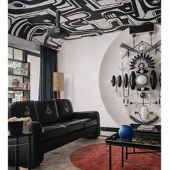 The media room in the 'Aria' project was envisioned as a space to wander and reflect. It features a hand-painted ceiling and a stunning wall installation by Klove Studio, turning the entire room into a whimsical, immersive art experience.