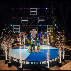 The winners' moment at the Red Bull BC One event, complete with stage lights and pyrotechnics. This is the kind of celebratory, high-impact shot that brands love.