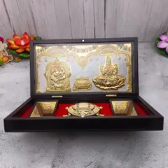 A luxurious Kubera Lakshmi gift box, featuring gold and silver plated idols, a tortoise diya, and yantras, all set in a beautiful wooden box.