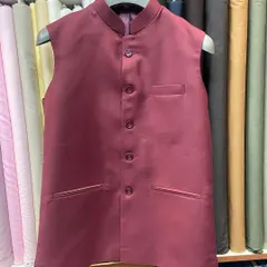 A finished custom Nehru jacket in a solid maroon fabric, shown on a hanger to display its clean lines and structure. This sleeveless jacket is a versatile staple for any man's ethnic wardrobe.