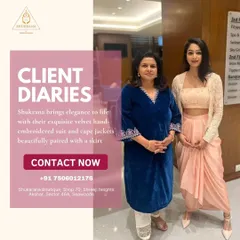 A client looking elegant in a velvet hand-embroidered suit, standing next to another client in a chic cape jacket paired with a dhoti skirt. This shows the range of my fusion wear.