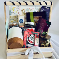 A closer look at our baby shower hamper, showcasing the curated items like Nutella, The Body Shop products, a photo frame, and essentials from The Moms Co.