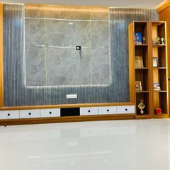 This is a finished TV unit combining wood-fluted panels with a large grey marble-finish center. The low-lying console offers ample storage with a mix of white and black drawers for a modern look.
