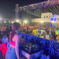 A wide shot of the Dandiya night event. You can see the huge stage setup with trussing and lights, and the massive crowd of people dancing in traditional attire. It was an incredible atmosphere.