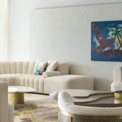 A moment of calm in the prestigious Kingfisher Towers. This living area showcases our tone-on-tone approach, with a plush cream sofa and sculptural tables set against a backdrop of the Bangalore city skyline.