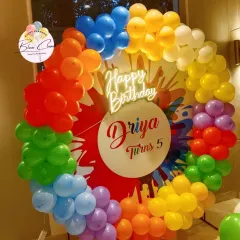 A vibrant color-splash or Holi-themed party decoration. This full balloon ring uses all the colors of the rainbow, perfect for an art party or a fun, colorful celebration.