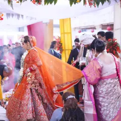 The bride's walk towards the mandap. This candid shot captures the movement and the traditional elements of a Hindu wedding ceremony.