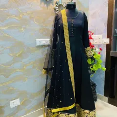 A classic black Anarkali suit with rich gold embroidery on the border and a matching sheer dupatta. This is a very elegant and regal choice for any formal occasion.