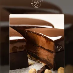 A slice of my decadent chocolate hazelnut cake. This dessert is pure indulgence, with rich chocolate mousse, a crunchy hazelnut base, and a glossy chocolate glaze.