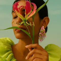 This is the vibe of my FLORAA collection. A model showcasing our handcrafted pink and green beaded earrings, designed to feel like a mini bouquet you can wear. It’s a perfect accessory for a garden wedding or a brunch look.