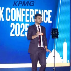 On stage at the KPMG Risk Conference, performing a routine with a Rubik's cube and my iPad. This act blends a physical puzzle with digital magic for a truly unique illusion.