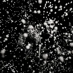 A creative black and white portrait using a spray of water to create a 'starburst' effect. This experimental technique results in a dynamic and abstract image that is full of energy.