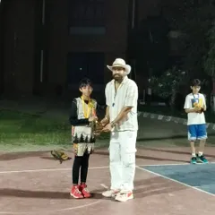 A player receives his trophy at the awards ceremony of the 3x3 basketball tournament. Every participant walks away with valuable experience and recognition.