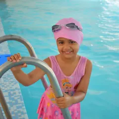 Look at that smile. My goal is to make every child feel confident and happy in the water. This is what successful first swimming lessons look like.