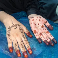 A Ghibli-inspired art style on the left, and a simple moon and stars design on the right. This shows how creative and fun minimal henna can be.
