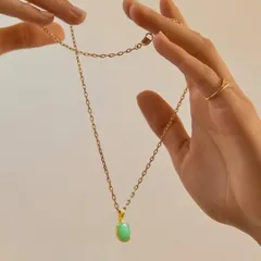 Minimal yet meaningful. This delicate gold chain with a soft green stone pendant is for those who find beauty in simplicity. It is the kind of timeless piece you will reach for every day.