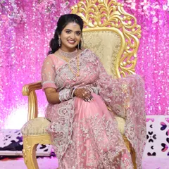 Here is one of our beautiful clients looking radiant on her reception day. She is wearing a modern American Diamond (AD) necklace set that sparkles beautifully under the lights. This set includes a layered choker and matching earrings, providing a glamorous look for contemporary events.