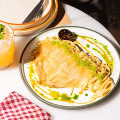A truly elegant pasta dish. I lay delicate salmon carpaccio over a bed of linguine tossed in a creamy yuzu butter sauce, finished with tobiko for a pop of texture. It's a unique fusion of Italian and Japanese flavors.