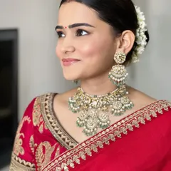 A side profile showing the soft, natural-looking makeup and the beautiful gajra in her hair. It's a look of pure, simple elegance.