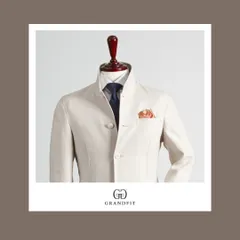 A closer look at the off-white Bandhgala, highlighting the precise button placement and the structure of the high collar. The subtle texture of the fabric adds depth and interest.