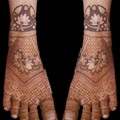 A full-coverage foot mehendi with a dense checkerboard pattern. The design is framed by a beautiful lotus band just above the toes, creating a slipper-like effect.