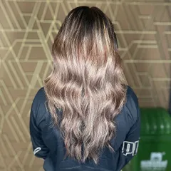 This custom balayage adds depth and dimension with sun-kissed shine. The soft waves perfectly showcase the hand-painted highlights.