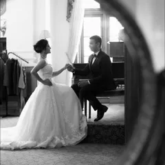 Using a mirror to frame this romantic piano scene adds a layer of artistry and depth. It's a creative approach to classic wedding photography ideas, making the portrait even more memorable.