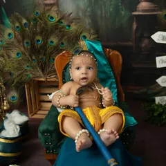 Look at this adorable little Krishna, sitting up with his flute and a curious expression. I capture both sleepy and awake moments during these themed sessions to show your baby's personality.