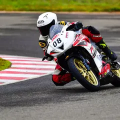 Meghana in action during her INMRC debut. This shot captures her focus and determination as she navigates a corner in the Stock 130-165cc Girls category.