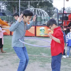 Friends share a laugh while playing with a hula hoop in our open green space. We have plenty of room for unstructured games and fun.