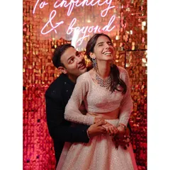 We love the pure, uninhibited joy of a wedding celebration. This moment with Shraddha and Mandela, laughing under a neon sign that says it all, perfectly captures the fun, modern, and slightly mad energy we love to document.