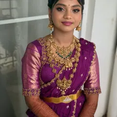 A beautiful portrait of Saanvi. The makeup is perfectly balanced to complement her intricate gold jewellery and the rich purple of her half saree.