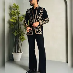 A client ready to steal the show in a stunning black velvet jacket. The rich gold floral embroidery provides a luxurious contrast, making this the perfect statement piece for a glamorous evening event.