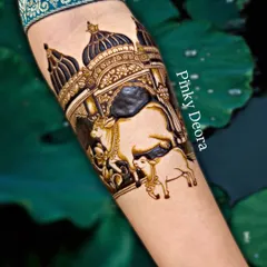 A stunning close-up of a Shreenathji design on the forearm. The contrast between the light and dark henna paste creates a powerful three dimensional effect, making the temple scene come alive.