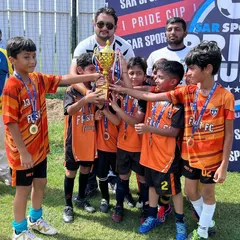 Our U8 team proudly displays their runners up trophy from the Pride Cup. We believe in introducing young players to competitive football early to build confidence and fundamental skills from the ground up.