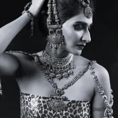 The same powerful look in black and white. This emphasizes the contrast and texture of the makeup and jewellery, showing how the look translates into monochrome for magazine editorials.