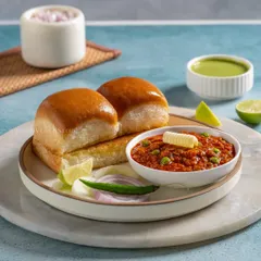 A classic Pav Bhaji, with soft, buttery pav buns and a rich, flavorful vegetable mash topped with a dollop of butter.