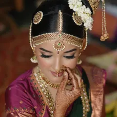 A close-up of a traditional Iyengar bridal look. Notice the precision in the eyeliner, the soft skin finish, and how the makeup perfectly complements the intricate hair jewelry. It’s all about creating a harmonious and divine look for the main ceremony.