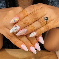 A perfect manicure for a special occasion, featuring soft pink nail extensions with silver heart details and subtle glitter accents. This romantic design is both sweet and elegant.