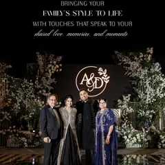 Bringing a family's style to life for an evening of celebration. This portrait shows the couple with the groom's parents at the reception. The mother's deep blue embroidered outfit and the father's classic suit perfectly complement the couple's shimmering monochrome ensembles.