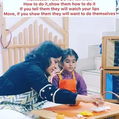 Our guiding principle is "Show them, don't tell them." In our prepared environment, a teacher gently demonstrates a practical life activity, allowing the child to observe and learn through action, not just words. This fosters deep concentration and a love for learning.
