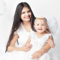 A mother and her little angel. The coordinating white outfits and happy smiles make this a heavenly portrait.