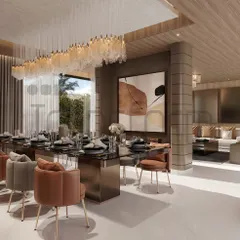 This dining area is a symphony of style, designed as part of an open-plan living space. The long, cascading chandelier defines the dining zone, while the mix of leather and fabric chairs adds textural interest.