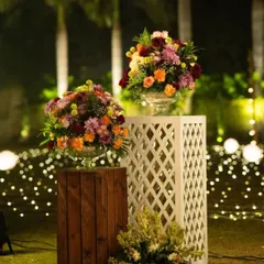 Another view of the floral pedestals, showing how they can be used to define a space or create a beautiful focal point in an outdoor or indoor setting.