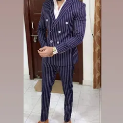 A bold statement with a navy pinstripe double-breasted suit. If you have a specific design in mind, I can create the same drape with my expert tailoring.